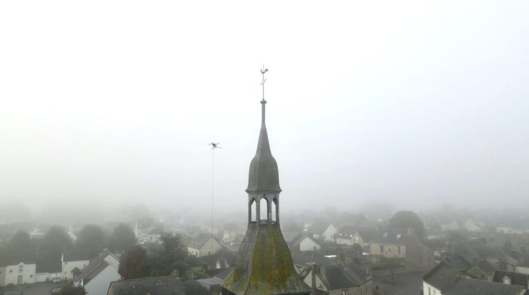 Drone pulvérisant des produits biodégradables pour le nettoyage de l’église à Torcé en Bretagne